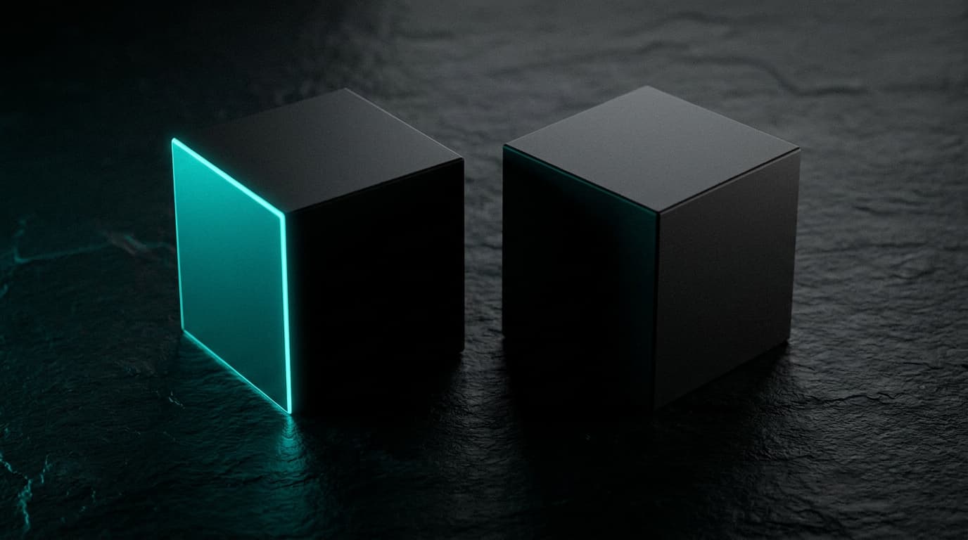 Two near-identical matte-black cubes on dark slate, one with bio-cyan rim light.